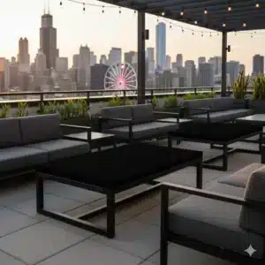 Premium outdoor event seating area with modern black tables and gray sofas, overlooking the Chicago skyline at sunset, ideal for social gatherings and corporate events.